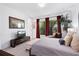 Elegant bedroom with a large window, chaise lounge, neutral tones, and stylish decor at 8723 Palm Ranches Pl, Tampa, FL 33614