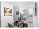 Open layout of dining area and kitchen with modern light fixtures and stainless steel appliances at 8723 Palm Ranches Pl, Tampa, FL 33614
