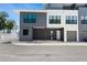 Contemporary townhouse with a gray and white facade, featuring a covered parking area at 8723 Palm Ranches Pl, Tampa, FL 33614