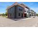 Modern townhome featuring a sleek gray exterior with clean lines and ample parking spaces for residents and visitors at 8723 Palm Ranches Pl, Tampa, FL 33614