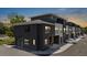 Modern townhouse with a sleek dark gray exterior and a well-lit parking area at 8723 Palm Ranches Pl, Tampa, FL 33614