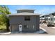 Modern two-story townhouse with gray facade, garage, and well-maintained landscaping at 8723 Palm Ranches Pl, Tampa, FL 33614