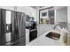 Modern kitchen featuring stainless steel appliances, sleek countertops, and ample natural light at 8723 Palm Ranches Pl, Tampa, FL 33614