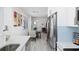 Kitchen with stainless steel appliances and dining area with glass table and contemporary decor at 8723 Palm Ranches Pl, Tampa, FL 33614
