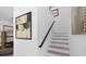 Elegant staircase with modern art and neutral decor leading to the upper level at 8723 Palm Ranches Pl, Tampa, FL 33614