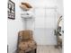Well-organized walk-in closet with shelving, hanging space, and a decorative chair at 8723 Palm Ranches Pl, Tampa, FL 33614