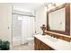 Well-lit bathroom features marble tile, stylish vanity, an ornate mirror, and a shower/tub combo at 9203 Meadow Lane Ct, Tampa, FL 33647