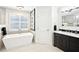 Bright bathroom with a free-standing tub, dark vanity, and contemporary lighting at 9203 Meadow Lane Ct, Tampa, FL 33647