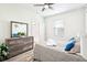 Bright bedroom with a dresser, large mirror, and a sunny window with blinds at 9203 Meadow Lane Ct, Tampa, FL 33647