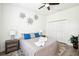 Cozy bedroom with a ceiling fan, two nightstands, and decorative flower wall art at 9203 Meadow Lane Ct, Tampa, FL 33647