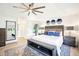 Spacious bedroom featuring a tray ceiling, large rug, and stylish decor and finishes at 9203 Meadow Lane Ct, Tampa, FL 33647