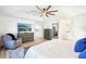 Bedroom with a trey ceiling, large TV, comfortable chair and a view of an exterior at 9203 Meadow Lane Ct, Tampa, FL 33647