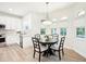 Eat-in kitchen with a round dining table, a pendant light, and large sunny windows at 9203 Meadow Lane Ct, Tampa, FL 33647