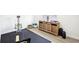 Bright exercise room featuring modern Total Trainer, stylish cabinet, and light wood flooring for functional home fitness at 9203 Meadow Lane Ct, Tampa, FL 33647