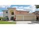 Stunning two-story home with a three car garage, tile roof, and mature landscaping at 9203 Meadow Lane Ct, Tampa, FL 33647