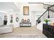 Grand foyer with high ceilings, modern decor, a staircase with an iron railing, and luxury vinyl flooring at 9203 Meadow Lane Ct, Tampa, FL 33647