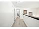 Hallway featuring light hardwood floors and white walls and trim at 9203 Meadow Lane Ct, Tampa, FL 33647