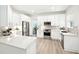 Modern kitchen featuring white cabinets, stainless steel appliances, and a herringbone backsplash at 9203 Meadow Lane Ct, Tampa, FL 33647
