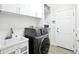 Clean, white laundry room features modern washer/dryer, ample storage, and practical design for efficient chores at 9203 Meadow Lane Ct, Tampa, FL 33647