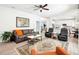 Bright living room with a ceiling fan, neutral colors, luxury vinyl flooring, and recessed lighting at 9203 Meadow Lane Ct, Tampa, FL 33647