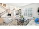 Bright living room with a soaring ceiling, plantation shutters, and a staircase with an iron railing at 9203 Meadow Lane Ct, Tampa, FL 33647