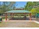 Covered picnic area with multiple tables near a green space and playground at 9203 Meadow Lane Ct, Tampa, FL 33647