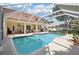 Sparkling pool area enclosed by a screen, perfect for relaxation and outdoor fun in a private setting at 9203 Meadow Lane Ct, Tampa, FL 33647