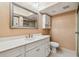 Bathroom with a vanity, mirror, and enclosed toilet at 93 Boca Ciega Point N Blvd # 93, St Petersburg, FL 33708