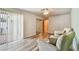 Bright bedroom features accent chairs, wood-look flooring, and sliding glass door access at 93 Boca Ciega Point N Blvd # 93, St Petersburg, FL 33708