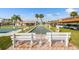 Outdoor view of a bocce ball court surrounded by sidewalks, benches, and palm trees at 93 Boca Ciega Point N Blvd # 93, St Petersburg, FL 33708