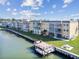 Condo exterior with screened lanais overlooks the canal with a personal pier and sitting area at 93 Boca Ciega Point N Blvd # 93, St Petersburg, FL 33708