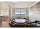 Cozy card room featuring an octagonal card table and seating with bright natural light at 93 Boca Ciega Point N Blvd # 93, St Petersburg, FL 33708