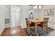 Cozy dining room with a light wood table, four chairs and a view to the entryway and kitchen at 93 Boca Ciega Point N Blvd # 93, St Petersburg, FL 33708