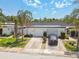 Attractive home exterior with well-manicured lawn, mature trees, and a clean, inviting facade at 93 Boca Ciega Point N Blvd # 93, St Petersburg, FL 33708