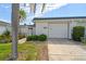 Charming home featuring a well-maintained front yard, decorative privacy wall and a one car garage at 93 Boca Ciega Point N Blvd # 93, St Petersburg, FL 33708