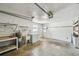 Well-lit garage showcasing laundry facilities, utility sink, workbench, and ample open space for various uses at 93 Boca Ciega Point N Blvd # 93, St Petersburg, FL 33708