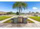 Outdoor grilling area with stone countertop, stainless steel grill, and concrete pavers at 93 Boca Ciega Point N Blvd # 93, St Petersburg, FL 33708