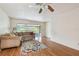 Bright living room featuring a cozy sofa, and sliding glass doors to the sunroom at 93 Boca Ciega Point N Blvd # 93, St Petersburg, FL 33708