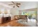Inviting living room with a ceiling fan, comfortable seating, and access to a screened porch at 93 Boca Ciega Point N Blvd # 93, St Petersburg, FL 33708