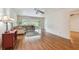 Bright living room featuring wood floors, a comfortable sofa, and sliding glass doors to the sunroom at 93 Boca Ciega Point N Blvd # 93, St Petersburg, FL 33708