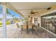 Covered patio with ceiling fans, concrete flooring, multiple tables, and a grill nearby at 93 Boca Ciega Point N Blvd # 93, St Petersburg, FL 33708