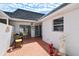 Private courtyard featuring red brick tile, a seating area, landscaping, and a privacy fence at 93 Boca Ciega Point N Blvd # 93, St Petersburg, FL 33708