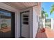 Charming patio area with classic tile flooring, white stucco walls, decorative lattice, and lush tropical plants at 93 Boca Ciega Point N Blvd # 93, St Petersburg, FL 33708