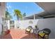Private courtyard featuring red brick tile, a seating area, landscaping, and a privacy fence at 93 Boca Ciega Point N Blvd # 93, St Petersburg, FL 33708