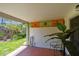 View of the tiled outdoor patio and lush backyard of the home at 93 Boca Ciega Point N Blvd # 93, St Petersburg, FL 33708