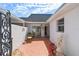An outdoor patio area with red tile, furniture and a small garden featuring a classical statue at 93 Boca Ciega Point N Blvd # 93, St Petersburg, FL 33708