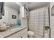 Bathroom with granite countertop, modern vanity, and a shower with a gray striped curtain at 9665 Sweetwell Pl, Riverview, FL 33569