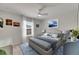 Bright bedroom featuring a ceiling fan, serene decor, and a comfortable bed with blue accents at 9665 Sweetwell Pl, Riverview, FL 33569