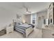 Bright bedroom features a ceiling fan, window, and stylish decor with a striped comforter on the bed at 9665 Sweetwell Pl, Riverview, FL 33569