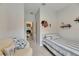 Cozy bedroom with nautical decor and connecting hallway at 9665 Sweetwell Pl, Riverview, FL 33569